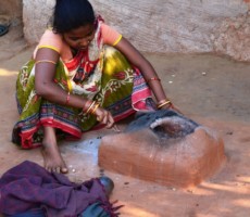 a lady cleaning the furnace after completion of firing the objects