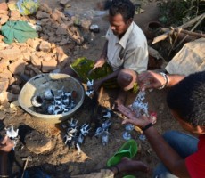 artisans removing the clay substance from the objects and preparing it for polishing