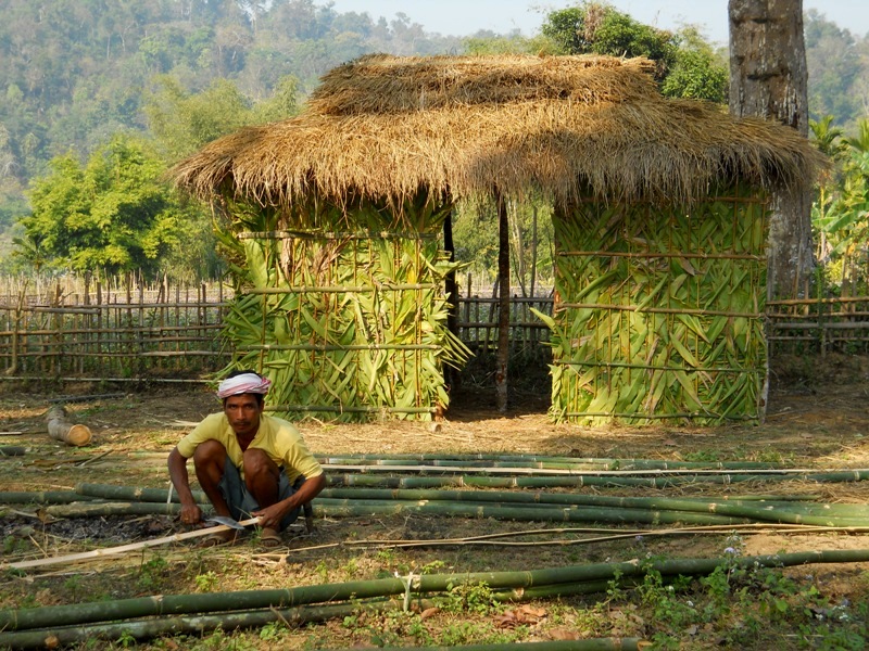 a bamboo artisan and a bamboo hut